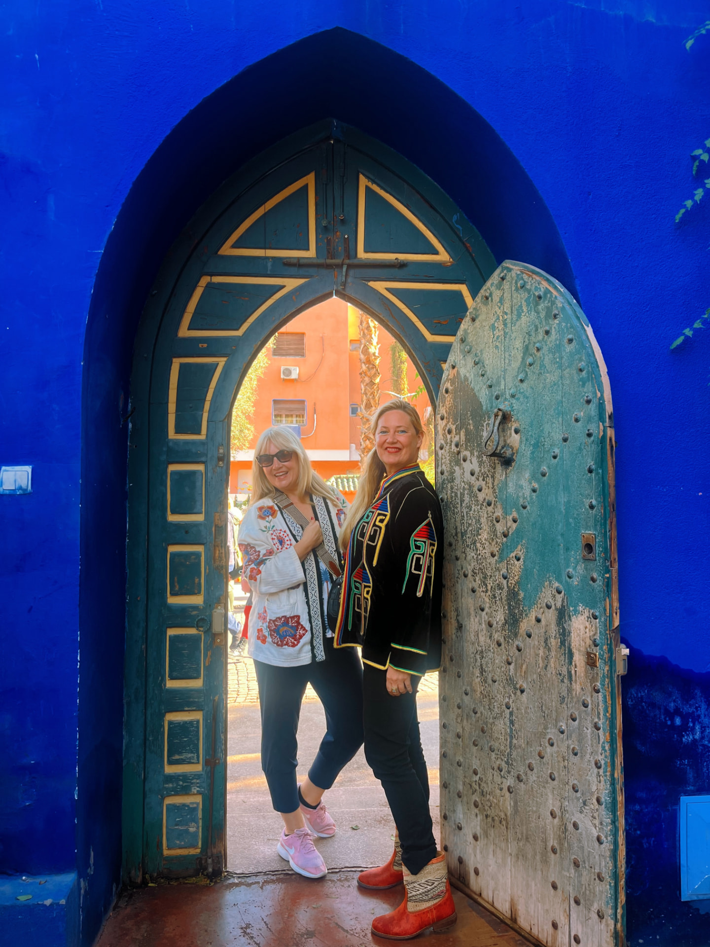 Zoe and Rebecca Russell-Turner, founders of Creative Journey Retreats, standing in a colourful arched doorway